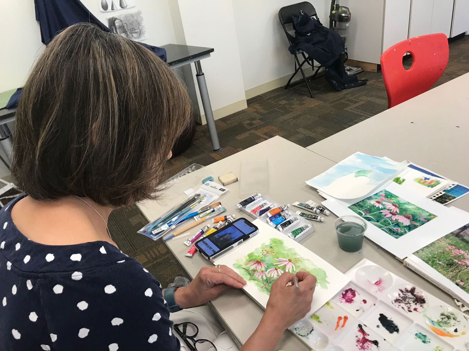 woman drawing and painting in art class
