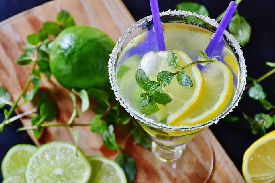 cocktail with lemon, mint, ice, and a salt rim made in a cocktail class