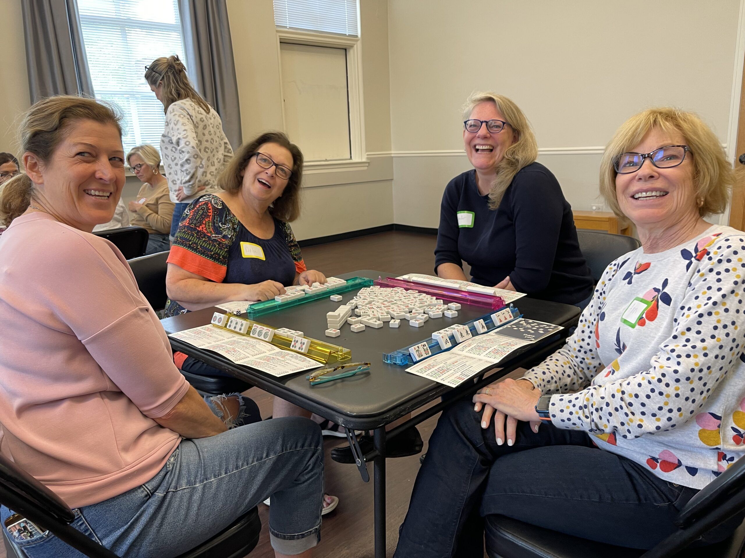 women around a table playing mahjong