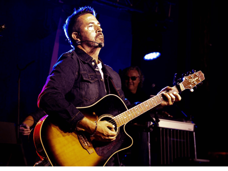 Musician performing at the Garth Experience event honoring Garth Brooks